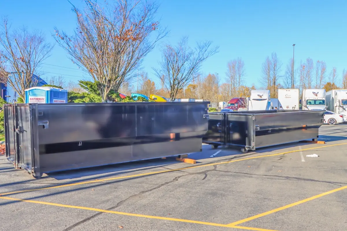 Professional dumpster rental service with roll-off container on residential driveway in Des Moines